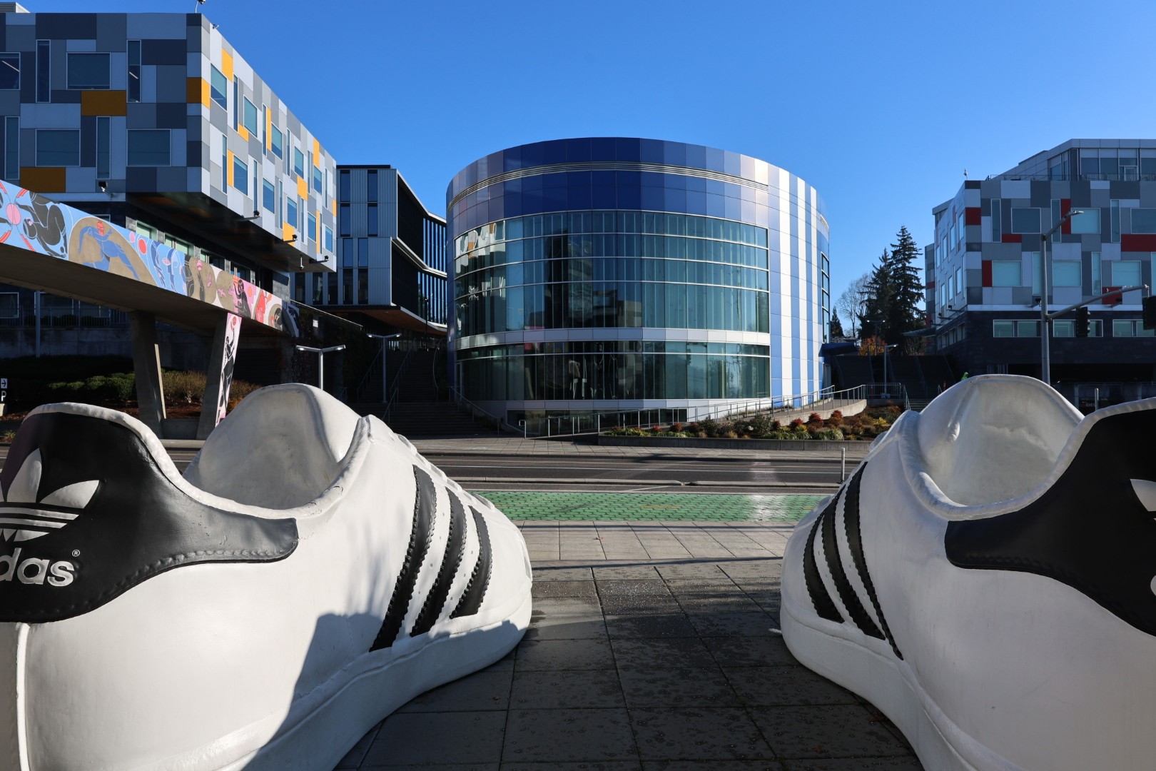Photo of Adidas building with Adidas shoes in the foreground.